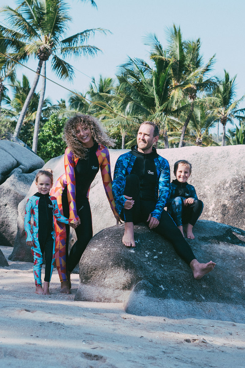 Family wearing Bravesuits on the beach